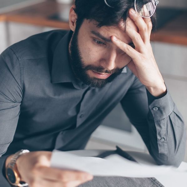 confused man looking over paperwork