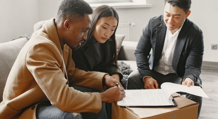 couple looking over paperwork with realtor