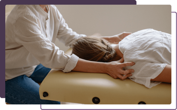 chiropractor adjusting a woman's shoulders