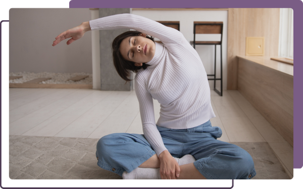 stretching lower back, on floor doing yoga