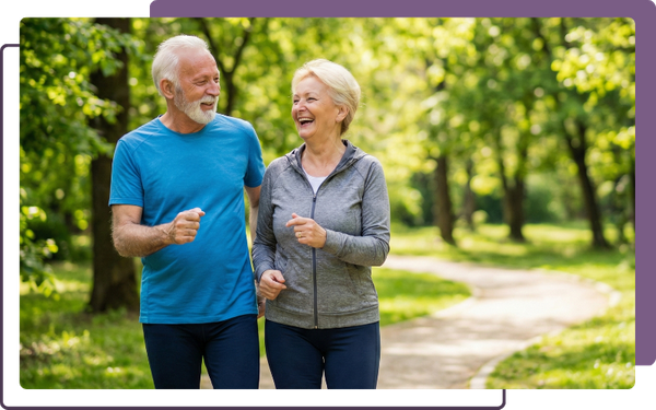 A healthy couple enjoying a walk in a park, illustrating the long-term wellness and mobility achieved through regular chiropractic care.
