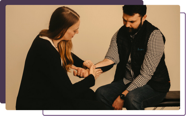Chiropractor helping patient with wrist