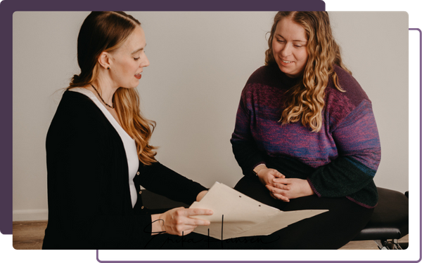 chiropractor talking to patient, showing paperwork