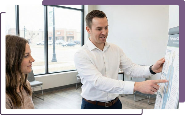 An encouraging chiropractor at Infinite Health Chiropractic providing a personalized consultation for a patient in Minot, North Dakota.