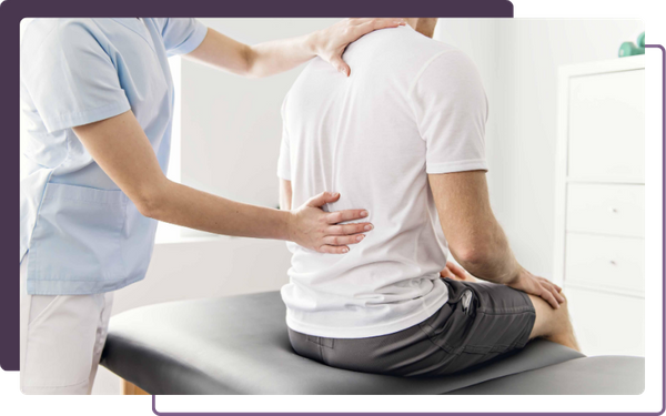 chiropractor adjusting back of patient 