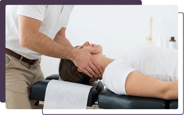 A professional male chiropractor carefully performs a cervical spine adjustment on a patient's neck in a clinical setting.