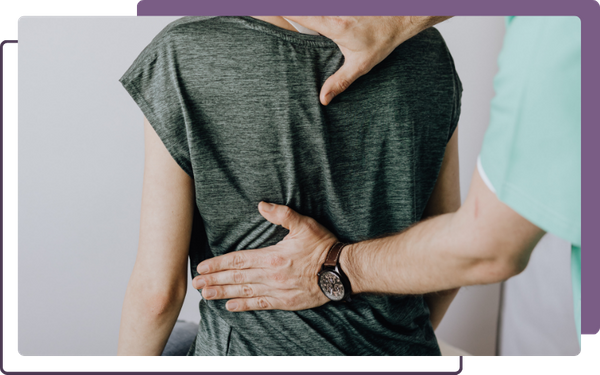 chiropractor with gentle hands on back