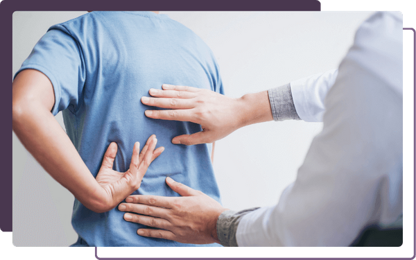 chiropractor examining a patients mid-back