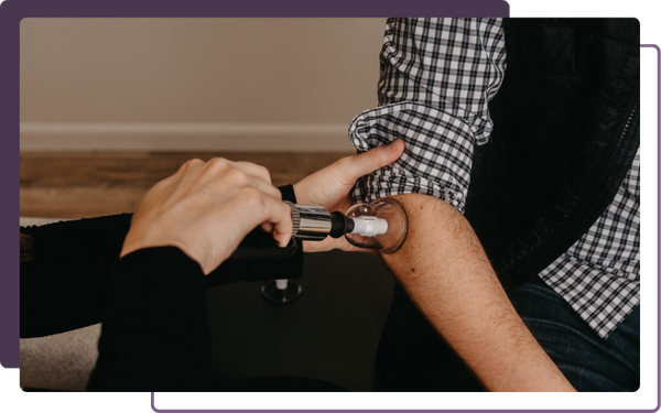 chiropractor treating elbow pain with cupping