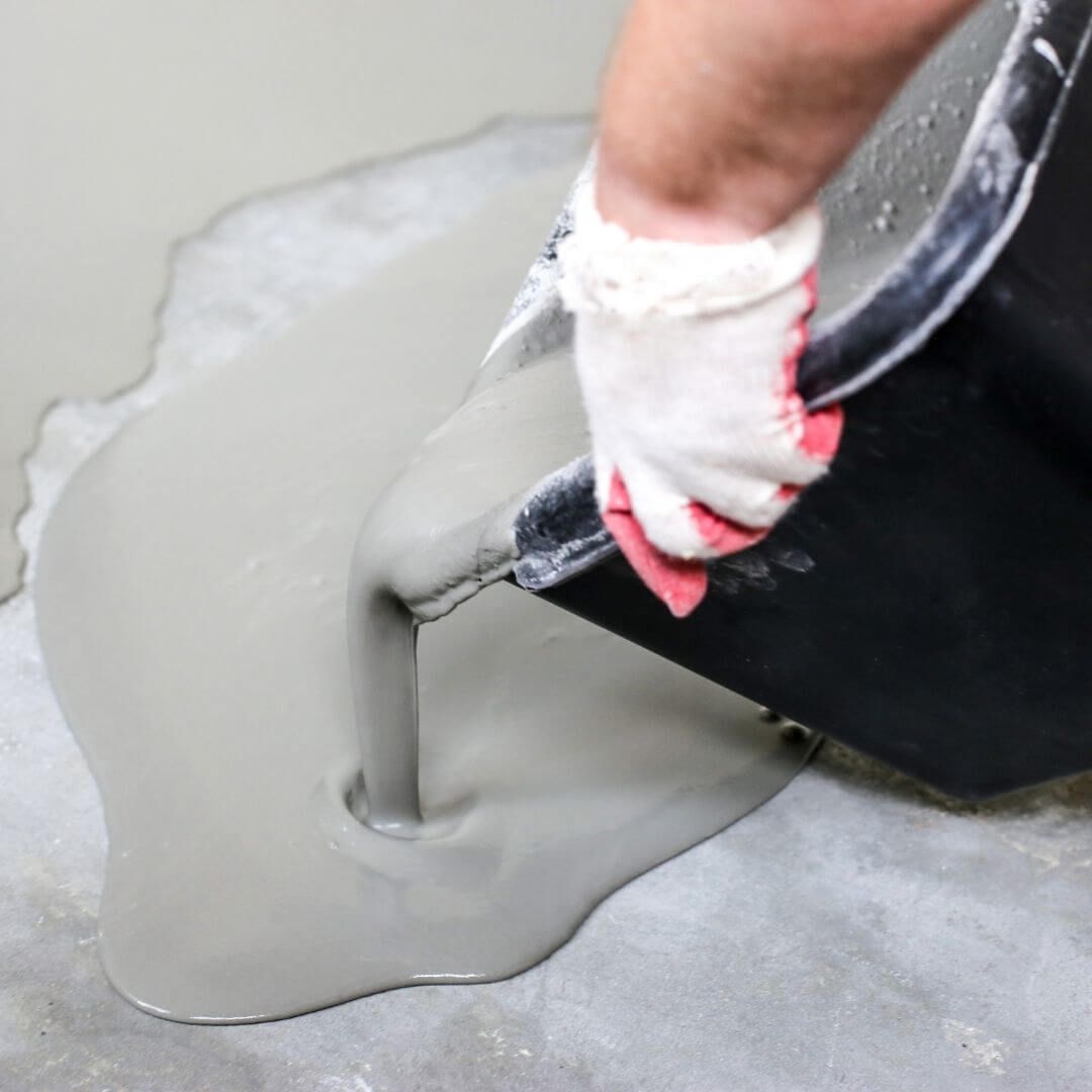 person pouring epoxy flooring