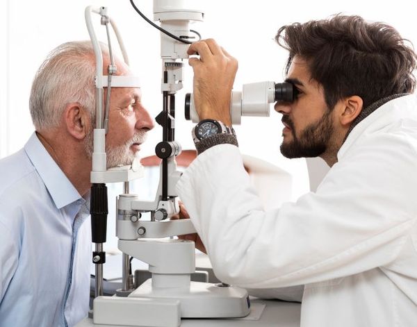 eye doctor looking into a client's eyes