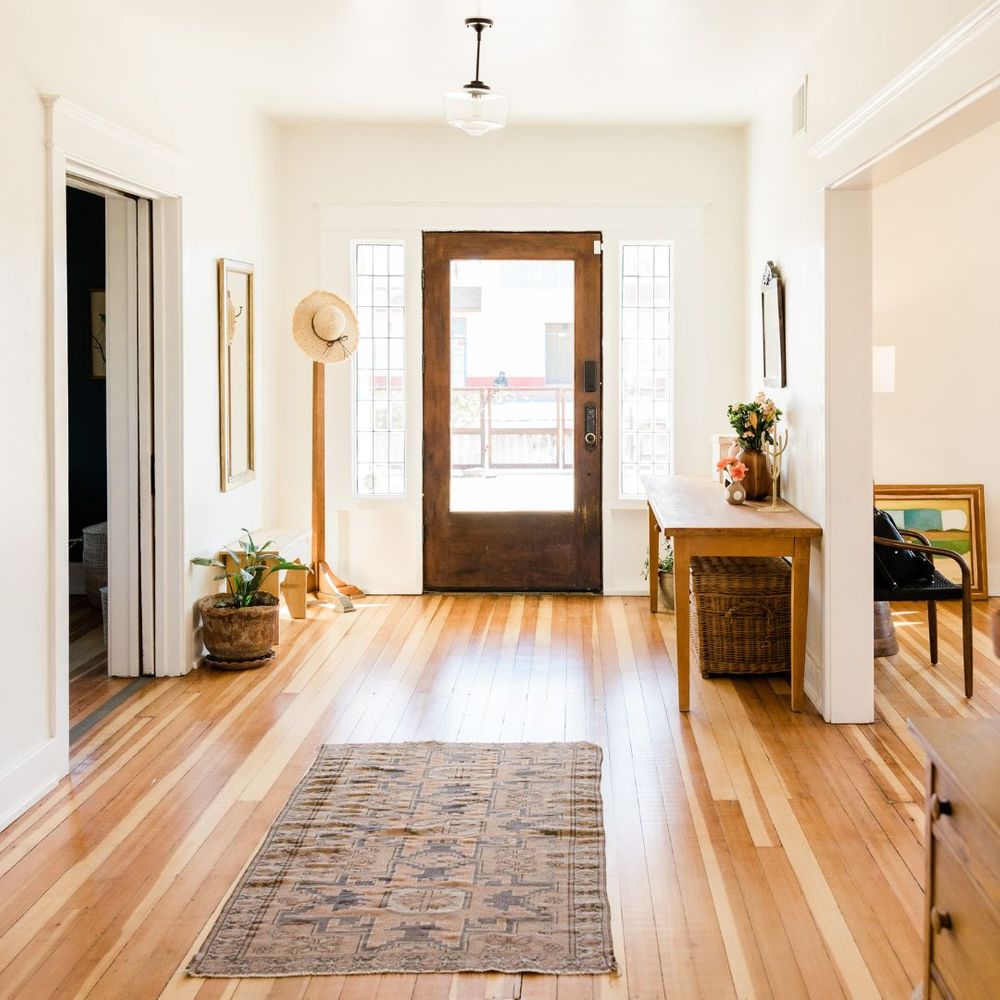 A nice hallway leading to the front door of a custom home