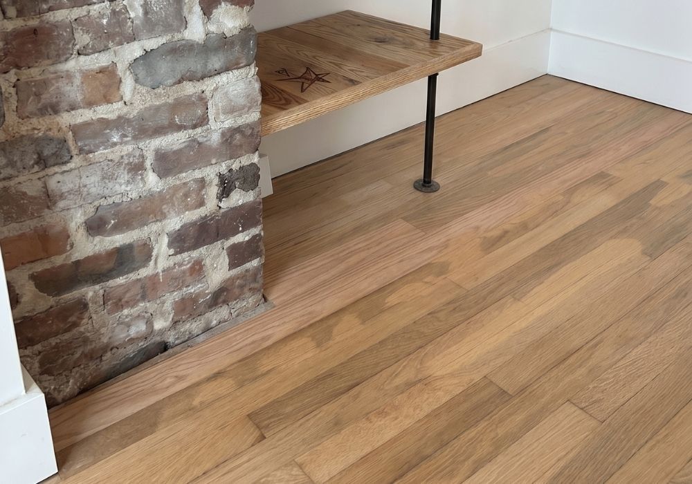 Hardwood flooring in corner showing smooth transition to wall