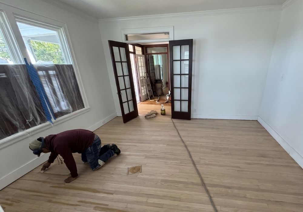Working on refinishing hardwood floor