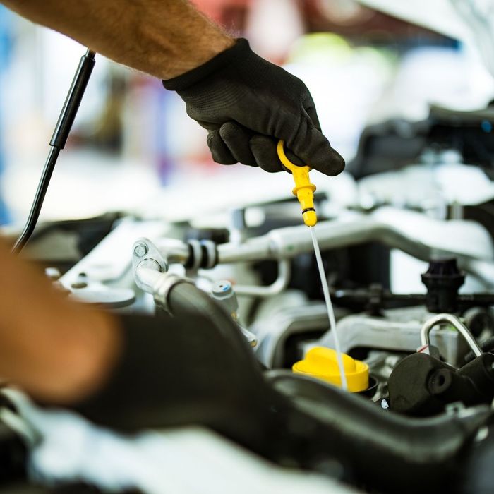 mechanic checking oil