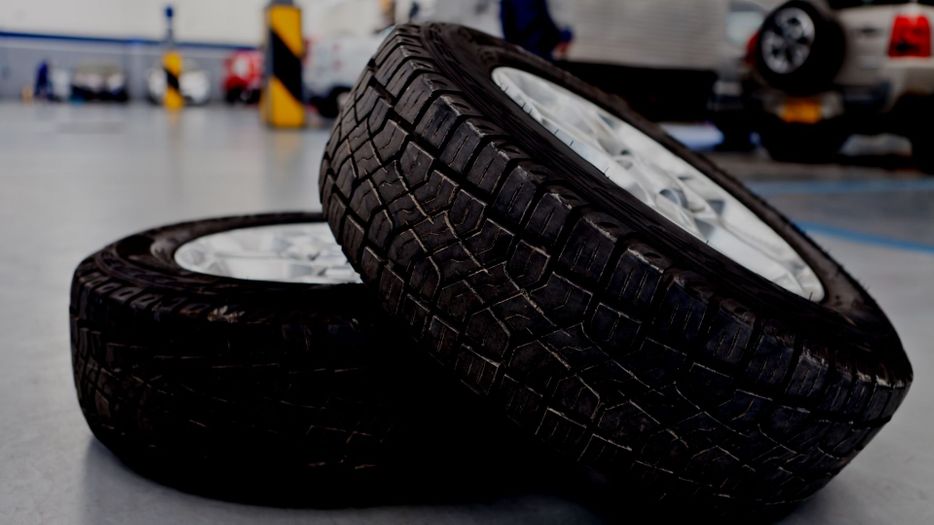 tires sitting on top of each other in a car shop