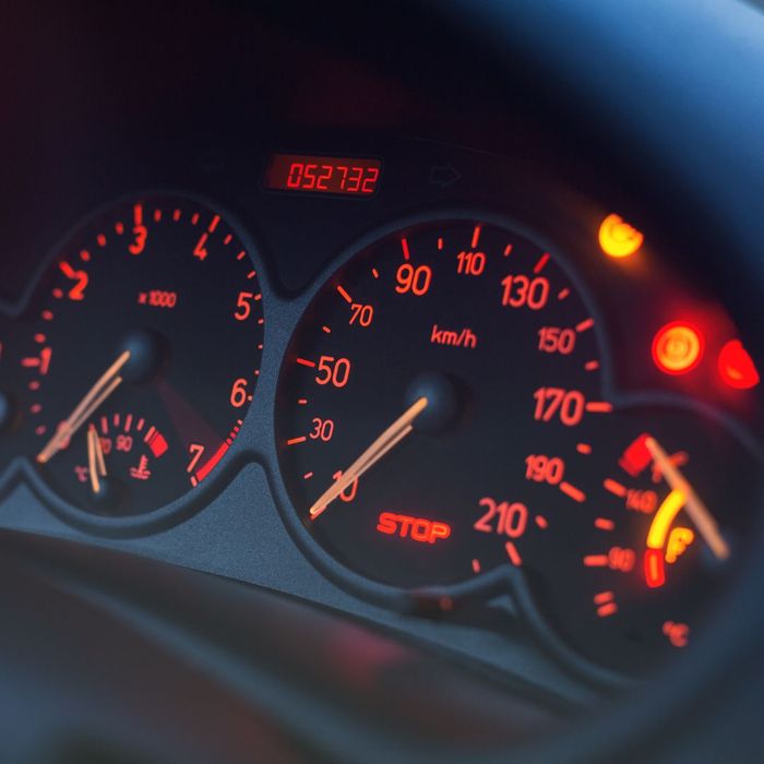 Car's dashboard with gauges and check engine lights