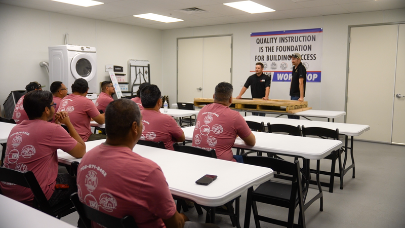 Thistle DKI team members attending an in-house mold remediation training session in a classroom