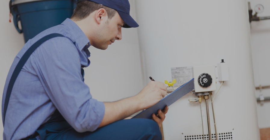 An image of someone working on a water heater.