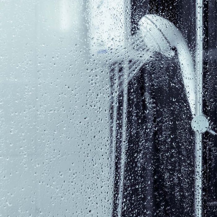 a shower head spraying cold water