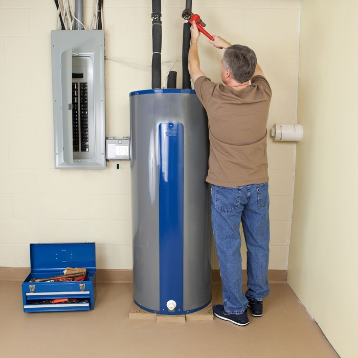 An image of a man working on a water heater. An image of a man working on a water heater.