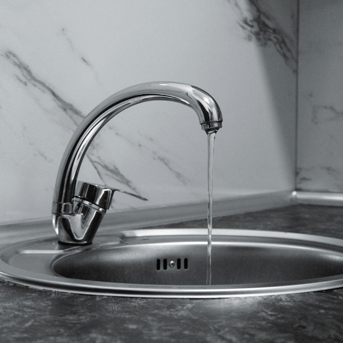 water slowly coming out of a faucet