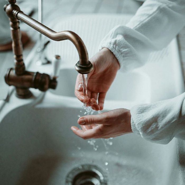 washing hands in kitchen sink