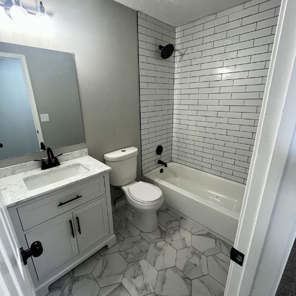 renovated batroom with grey and white tiles