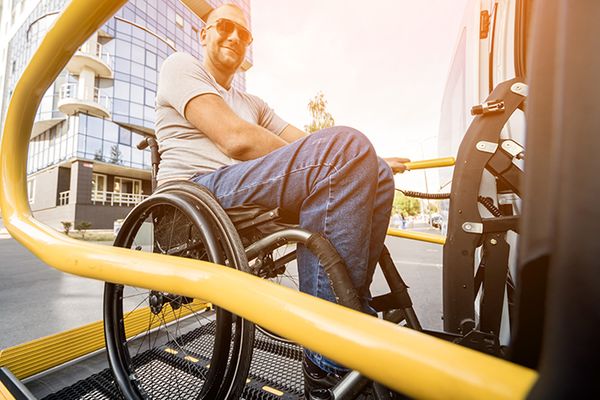 man in a wheel chair sitting on a ramp