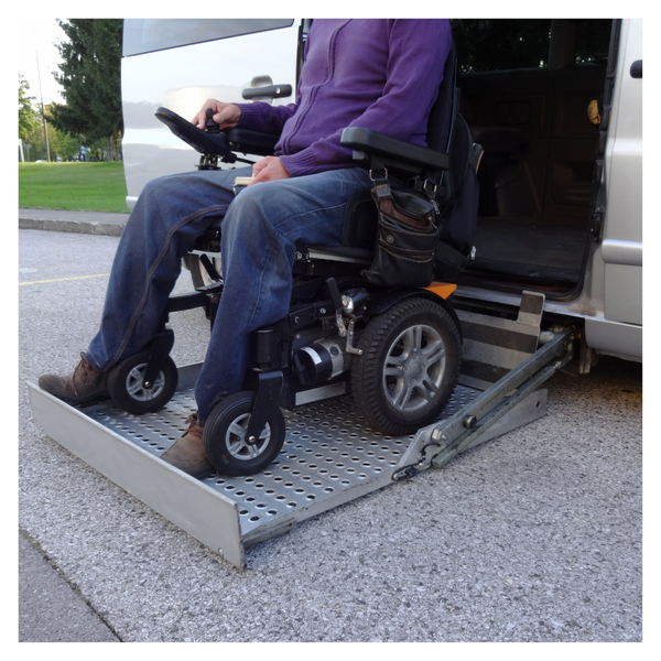 person in a wheelchair getting in a van