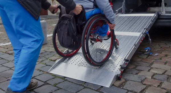 pushing a wheelchair into a van