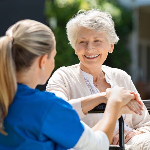 elderly woman smiling to helper