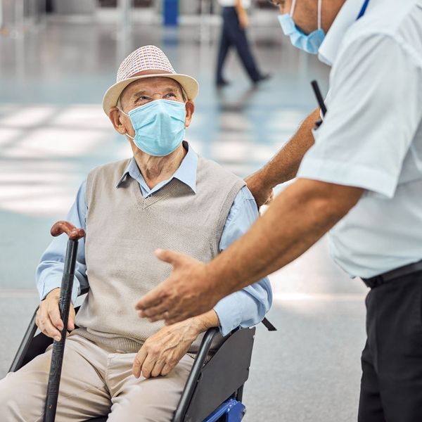 elderly man in wheelchair in the airport