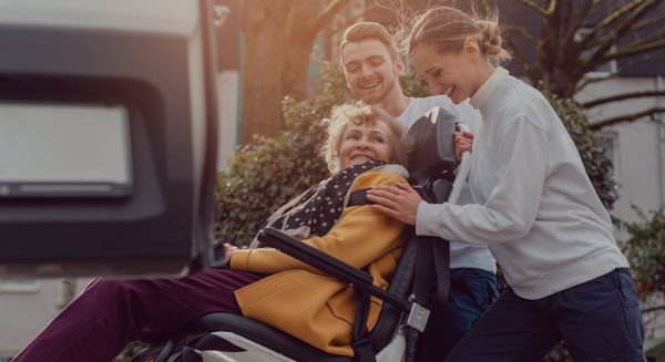 pushing a woman in a wheelchair