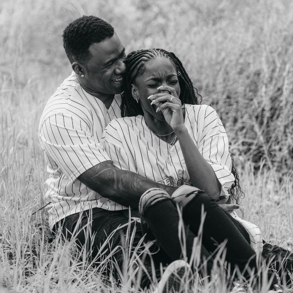 happy couple sitting in a field