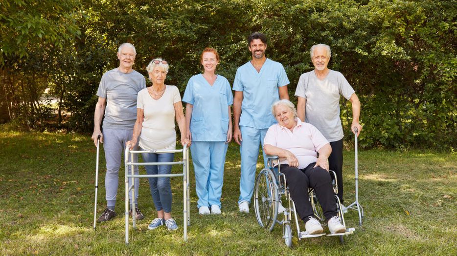 group of nurses and disabled adults
