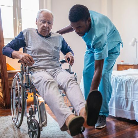 nurse helping disabled adult at home