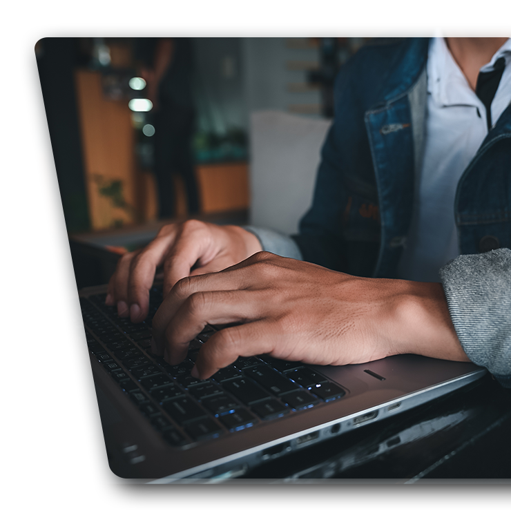 Photo of a man typing on a computer