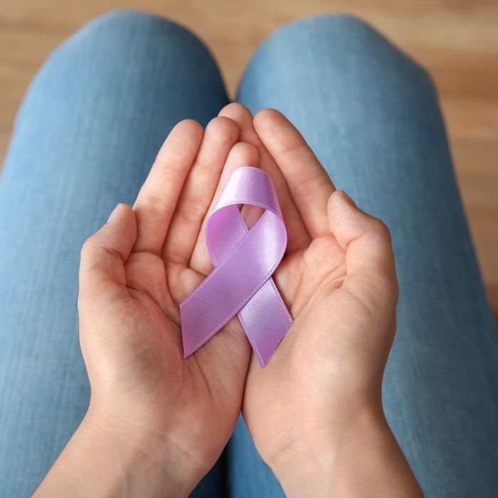 person holding pink ribbon person holding pink ribbon