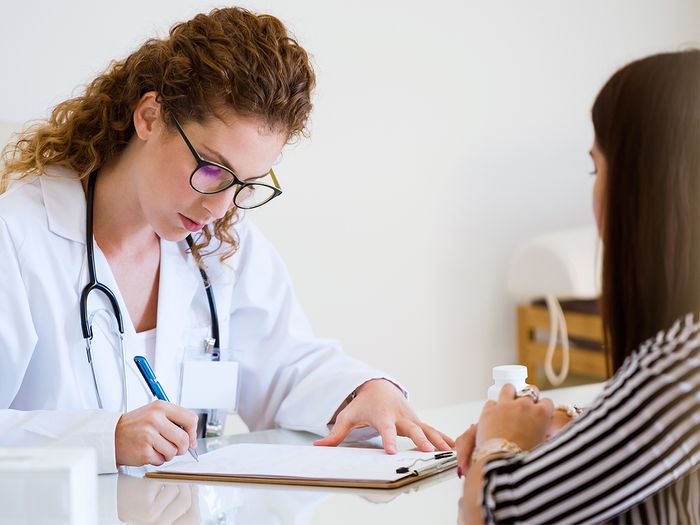 Woman talking to a female doctor in office Woman talking to a female doctor in office