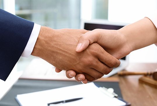 Image of a lawyer shaking hands with a client