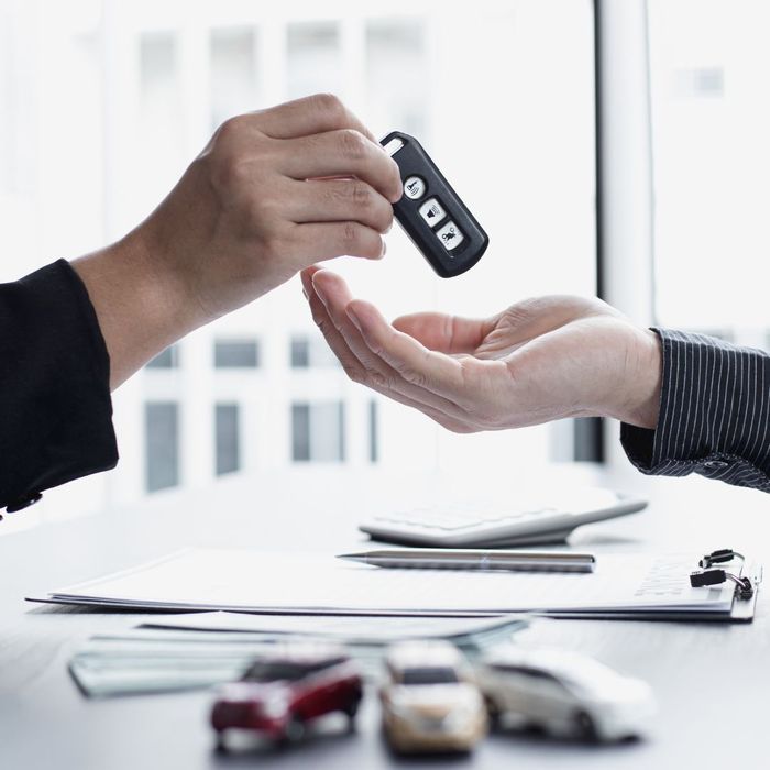 agent handing key to car owner
