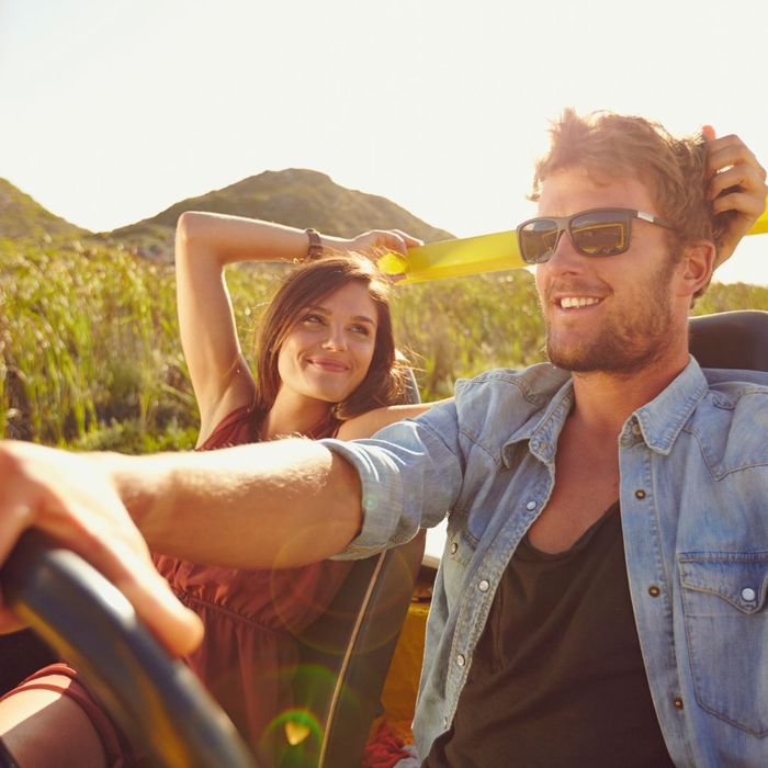 man and woman driving open jeep