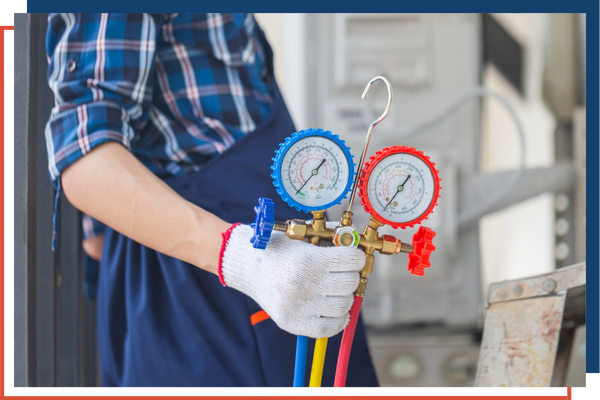 HVAC tech standing next to a gauge