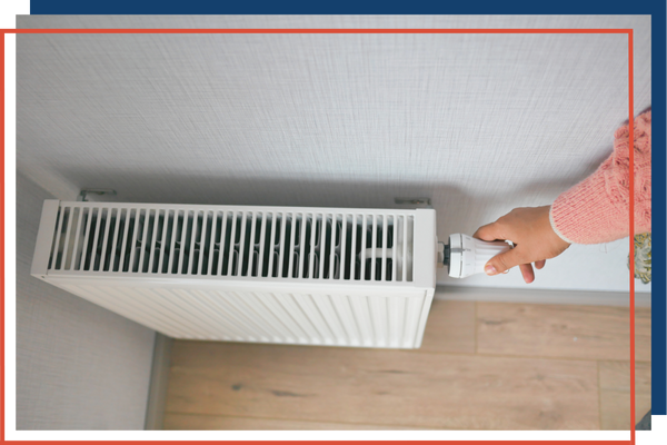 Woman turning on a heating unit