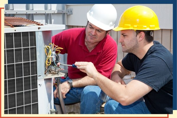 two HVAC techs repairing AC unit two HVAC techs repairing AC unit
