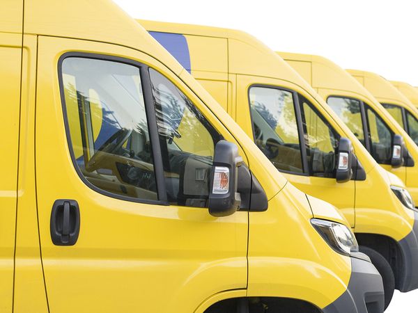 Yellow fleet vans lined up in a row.