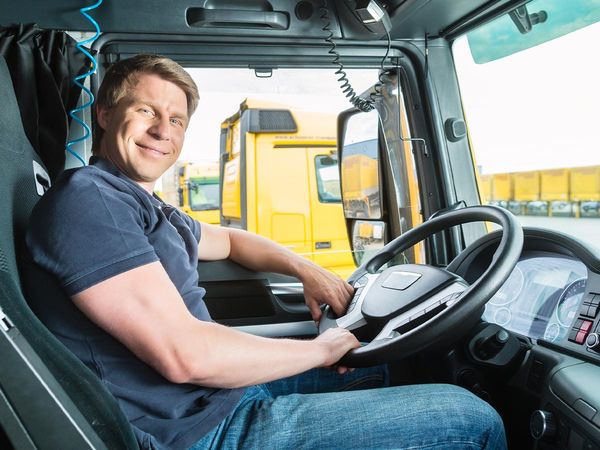 a happy truck driver behind the wheel