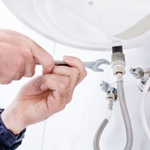 plumber adjusting sink drain