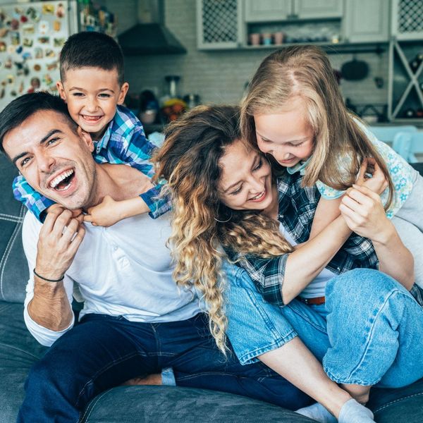 Two young parents and kids laughing